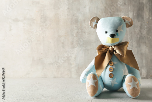 Toy bear with taped mouth a...