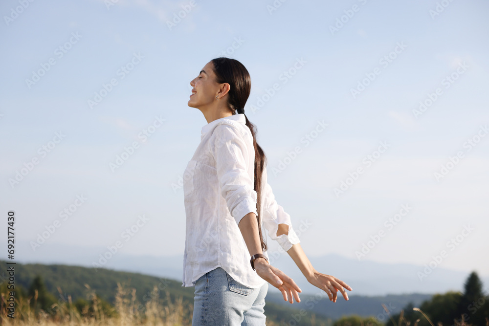 Feeling freedom. Happy woman enjoying nature outdoors