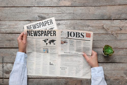Woman reading newspaper on ...
