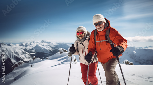 Happy elderly couple skiing. Mountain winter snowy landscape. Action shot.