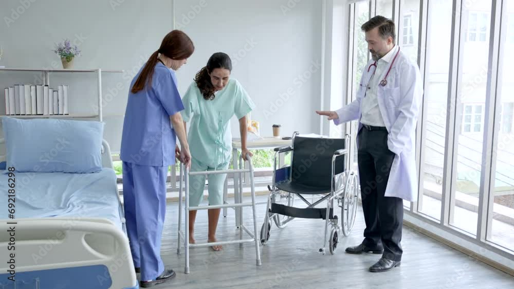 Nurse help women patient with walking aids after received a treatment, doctor standing observation, patient happy for cure and can walk again. Nurse help women patient with walking aids after received a treatment, doctor standing observation, patient happy for cure and can walk again.