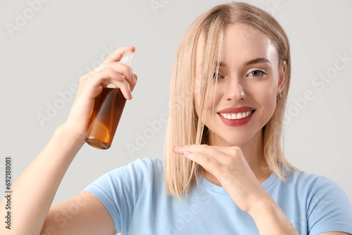 Young blonde woman applying...