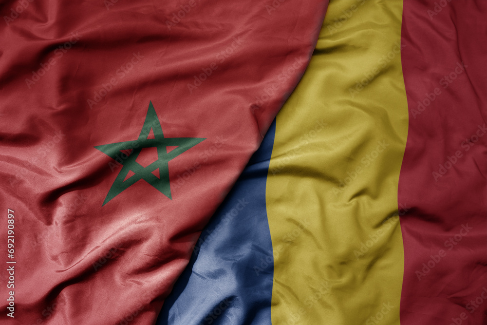big waving national colorful flag of romania and national flag of morocco . big waving national colorful flag of romania and national flag of morocco .