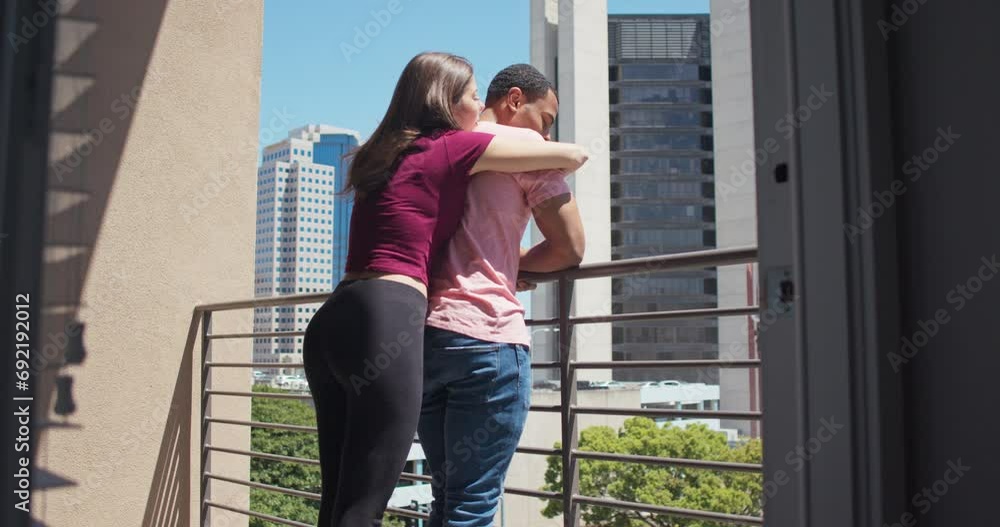Woman hanging on her boyfriends back while they look out over the city on a sunny day. Low angle rear view of couple standing on their apartment balcony. 4k slow motion handheld Woman hanging on her boyfriends back while they look out over the city on a sunny day. Low angle rear view of couple standing on their apartment balcony. 4k slow motion handheld