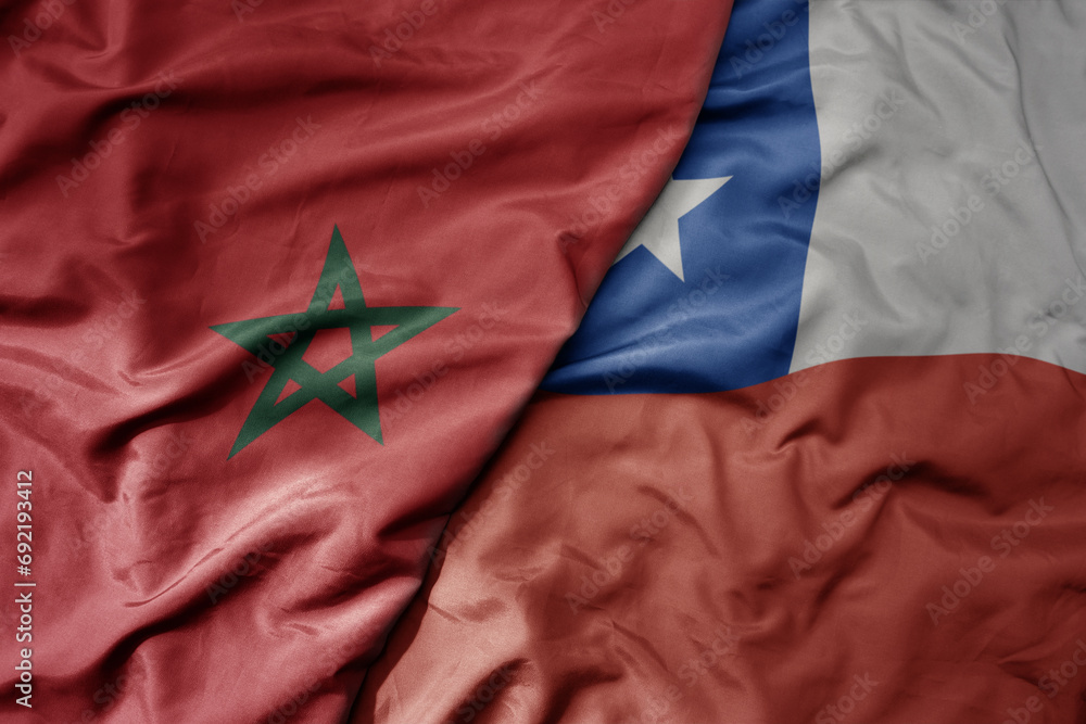 big waving national colorful flag of chile and national flag of morocco . big waving national colorful flag of chile and national flag of morocco .