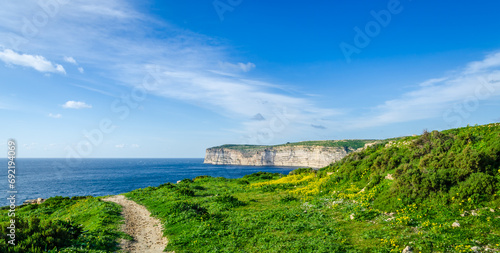 Rocky limestone coastline of Gozo island and Mediterranean Sea with turquoise blue water and caves.Great spot for hiking along Maltese coast.Popular walking clifftop Xlendi walk with spectacular views