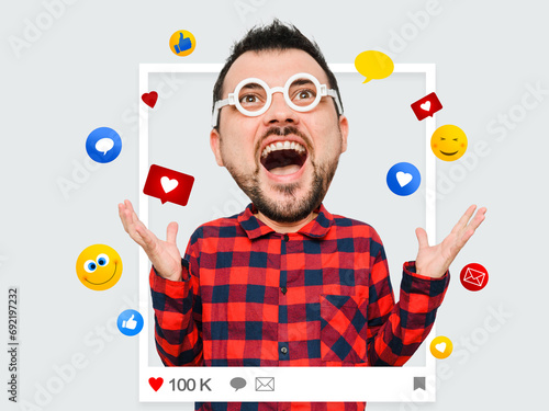 Emotional portrait of funny blogger man with like and comments ison photo