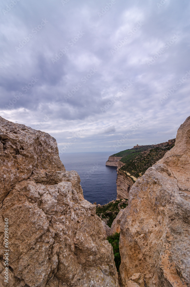 Sea and Dingli cliffs seen through a rocky window, Dingli, Malta