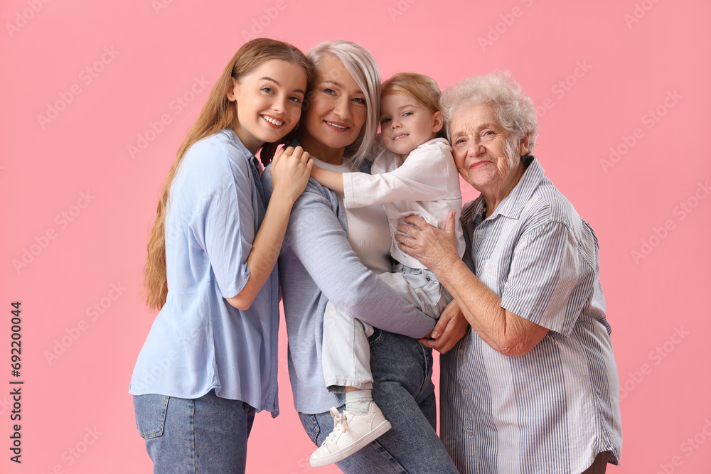 Little girl with her family hugging on pink background Little girl with her family hugging on pink background
