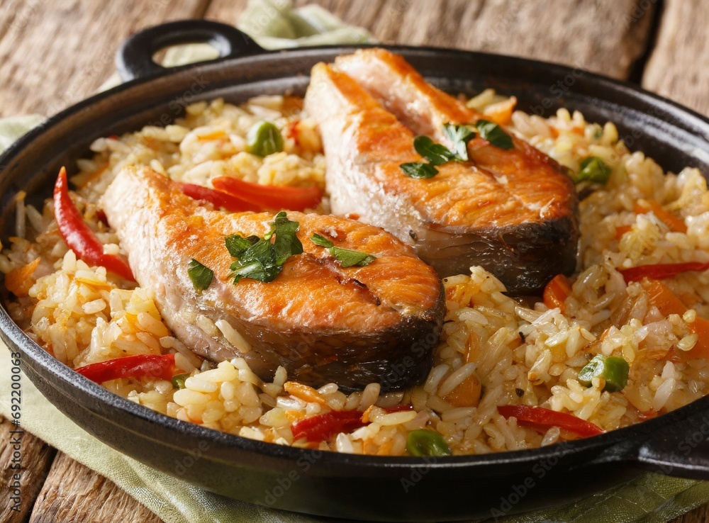 Asian spicy pilaf with fish steaks close-up