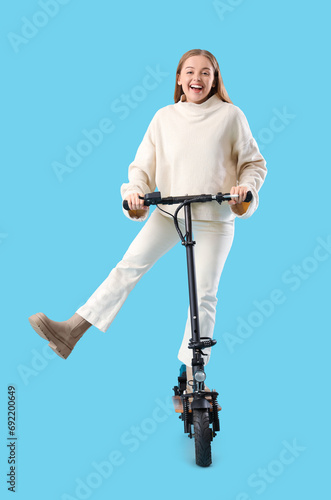 Happy young woman riding el...