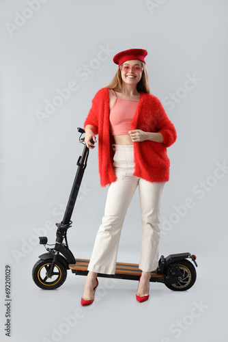 Stylish young woman with el...