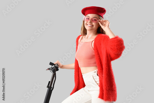 Stylish young woman with el...
