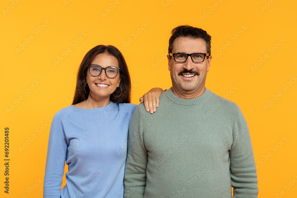 European retired glad woman and man with glasses, standing shoulder to shoulder European retired glad woman and man with glasses, standing shoulder to shoulder
