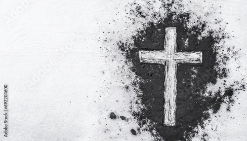 Christian cross drawing in ash as symbol of religion. Sacrifice, Jesus Christ, Ash Wednesday concept © Paula