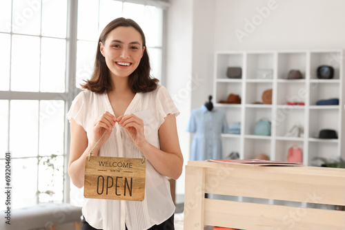 Female seller with OPEN sig...