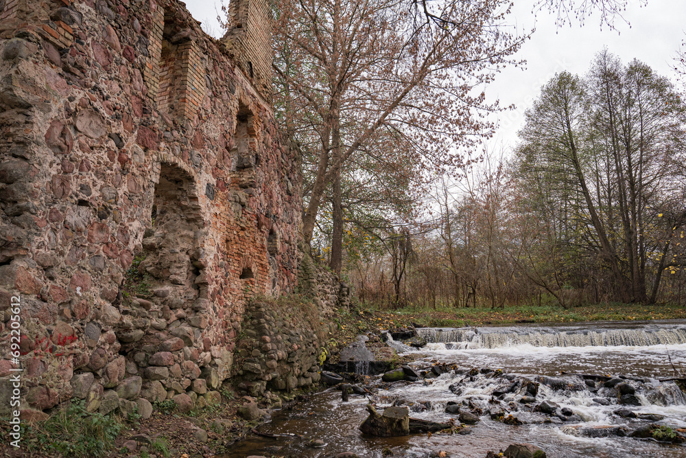 A waterfall formed after the destruction of an old mill A waterfall formed after the destruction of an old mill