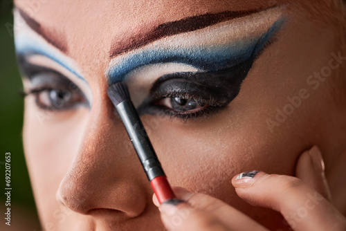 Konstfotografi Close up of male performer doing dramatic eye make up, copy space