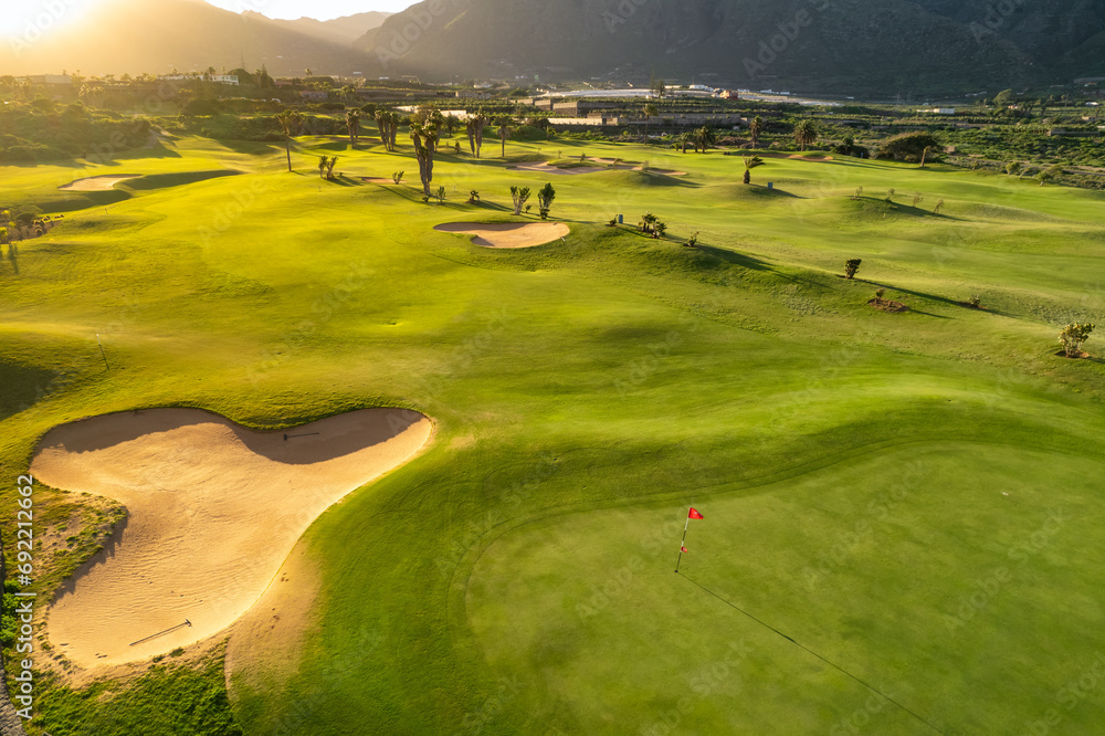 Aerial view of a golf club field at sunset on Tenerife Island, Spain.