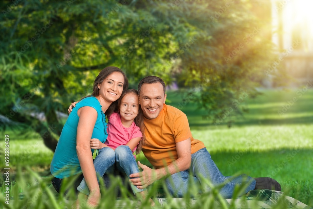 Parents with cute child playing in park Parents with cute child playing in park