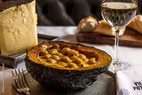 Pumpkin stuffed with gnocchi cheese and a glass of white wine