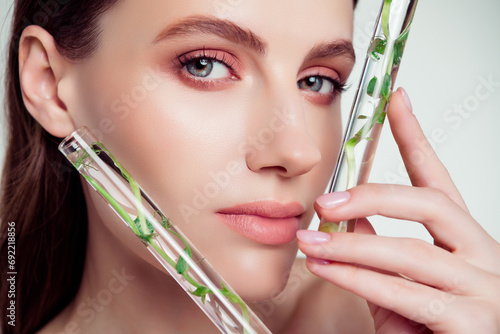 Photo of attractive lady beautician creating modern bio cream serum in test tube for smooth gentle tender skin photo