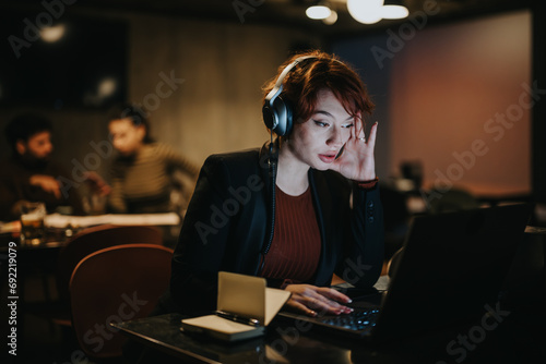 A businesswoman working late at night in a corporate office, analyzing data and doing paperwork for a project, planning for business growth.