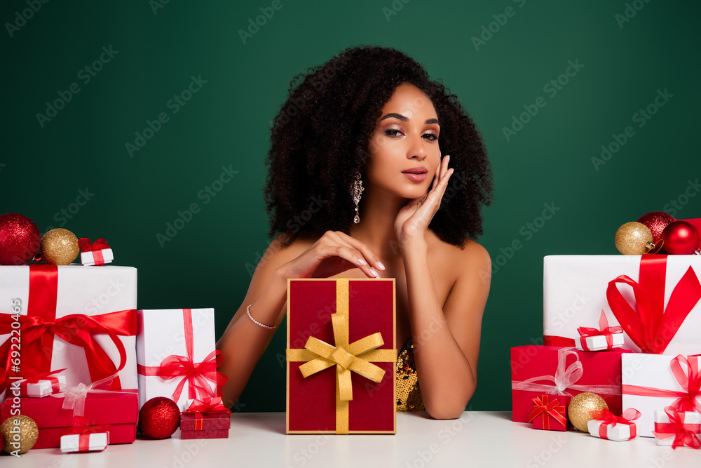 Photo of charming chic girl sit table in christmas festival market advertise wis dream giftbox over green background - obrazy, fototapety, plakaty 