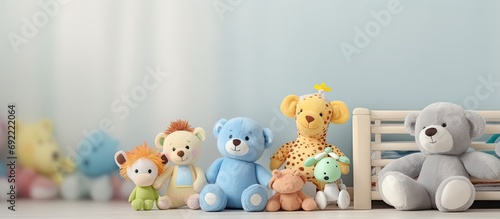 baby monitor camera between stuffed animals and toys on the crib shelf. Copy space image. Place for adding text or design photo