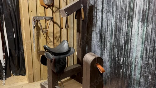 Prison room with wooden walls with medieval tools for torture and pain. Equipment for torture photo
