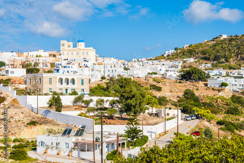 View of white houses and church on hill in Kimolos village, Kimolos island, Cyclades, Greece