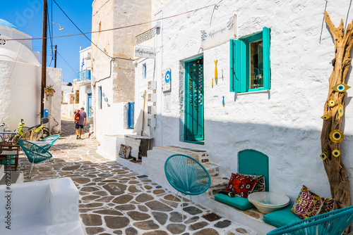 KIMOLOS ISLAND, GREECE - SEP 26, 2023: shop located in narrow street with typical Greek style architecture in Kimolos village, Kimolos island, Cyclades, Greece. © pkazmierczak