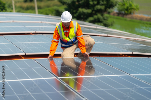 Engineer man is working to construct solar panels system on roof. Installing solar photovoltaic panel system. Alternative energy ecological concept. Renewable clean energy technology concept.