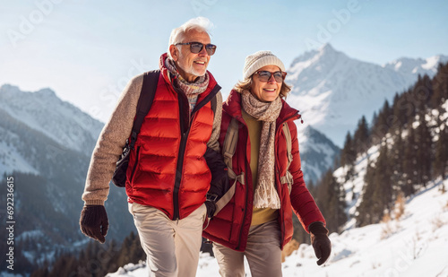 Senior couple walking in the winter mountains
