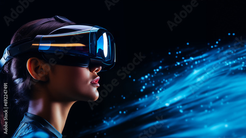 Pretty young woman in VR glasses exploring virtual reality with a virtual reality headset on black background © Mrt