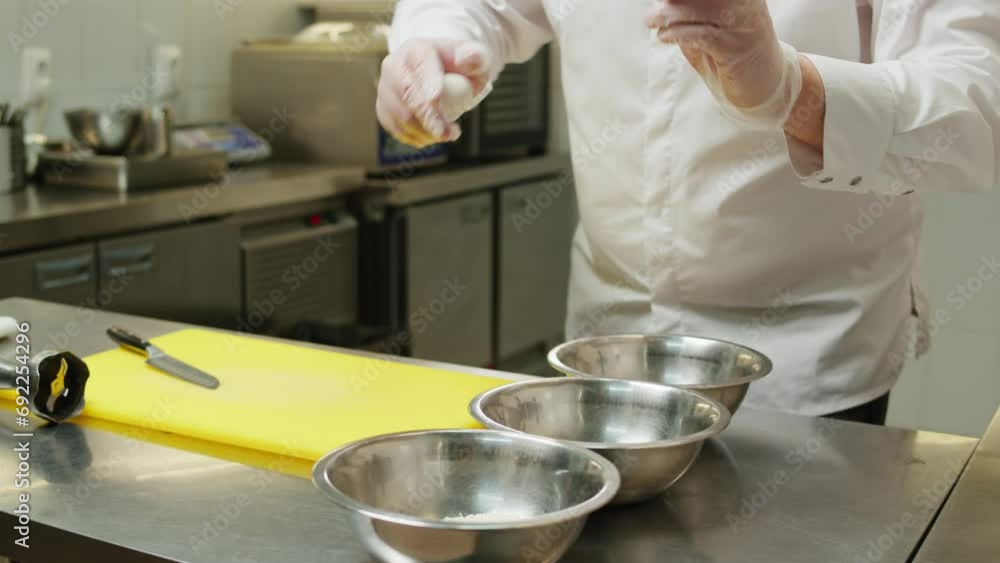 Professional kitchen. Chef doing some dough with eggs and flour close-up, pastry head- chef, backery Professional kitchen. Chef doing some dough with eggs and flour close-up, pastry head- chef, backery
