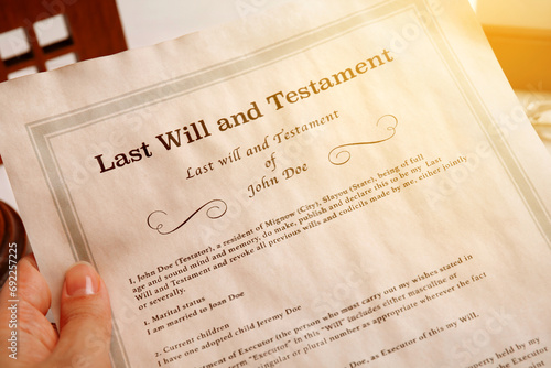 Woman holding Last Will and Testament at table, closeup