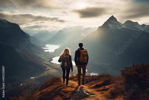 Photo of a young couple hiking in a breathtaking mountain landscape. Generative AI © Aditya