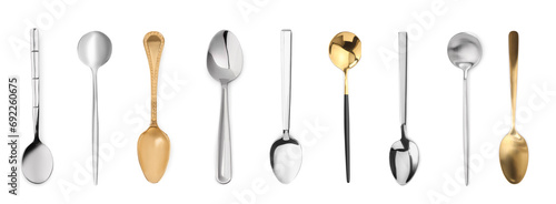 Stylish golden and silver spoons on white background