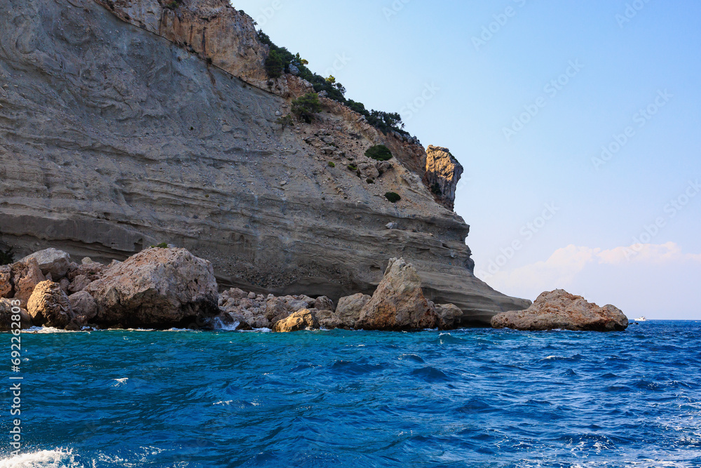 Obraz premium View of the rocky shore from the sea. Mediterranean Sea in Turkey. Popular tourist places. Background