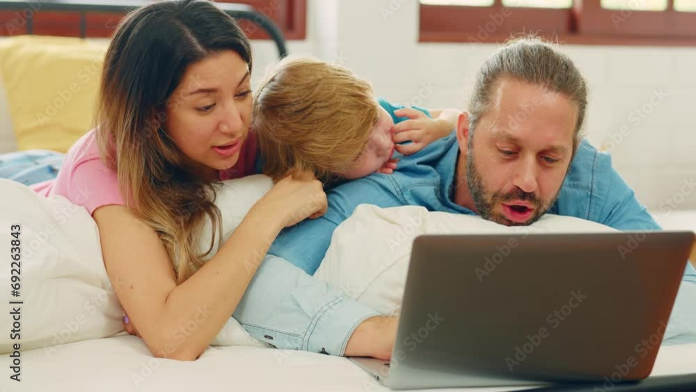 Caucasian attractive family use laptop on bed in the morning at home. Caucasian attractive family use laptop on bed in the morning at home.