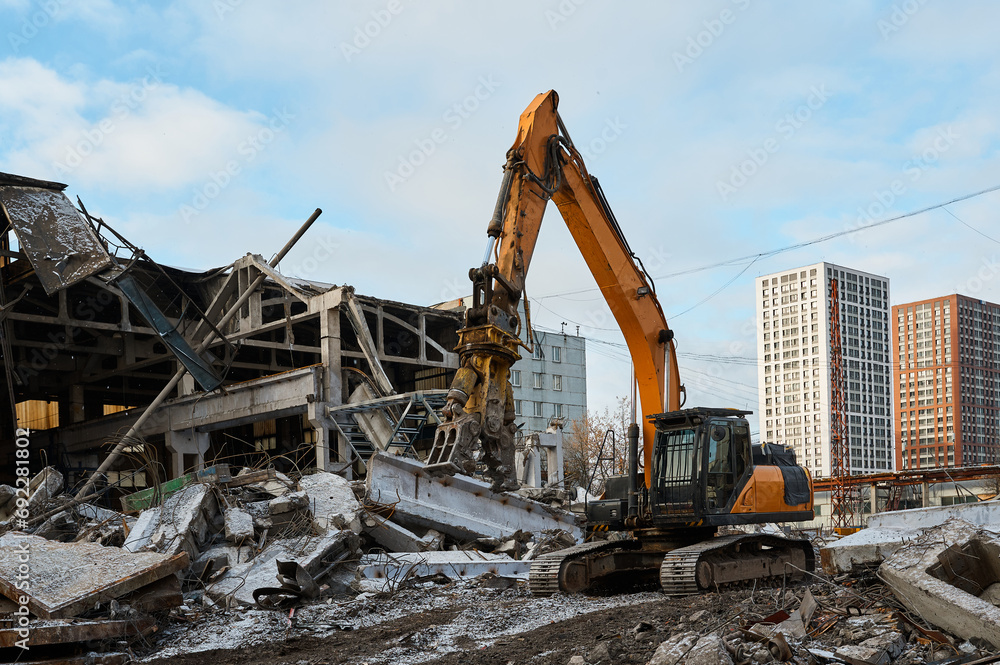 Yellow excavator destroys armored concrete plates and beams Yellow excavator destroys armored concrete plates and beams
