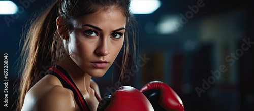 Female Muay Thai boxer training at gym