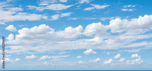 blue sky background with clouds. wide web banner. Blue sky and white clouds floated in the sky on a clear day with warm sunshine combined with cool breeze
