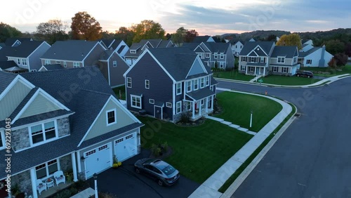 New neighborhood in USA suburb. Aerial shot of large, modern houses and homes during sunset in autumn. photo