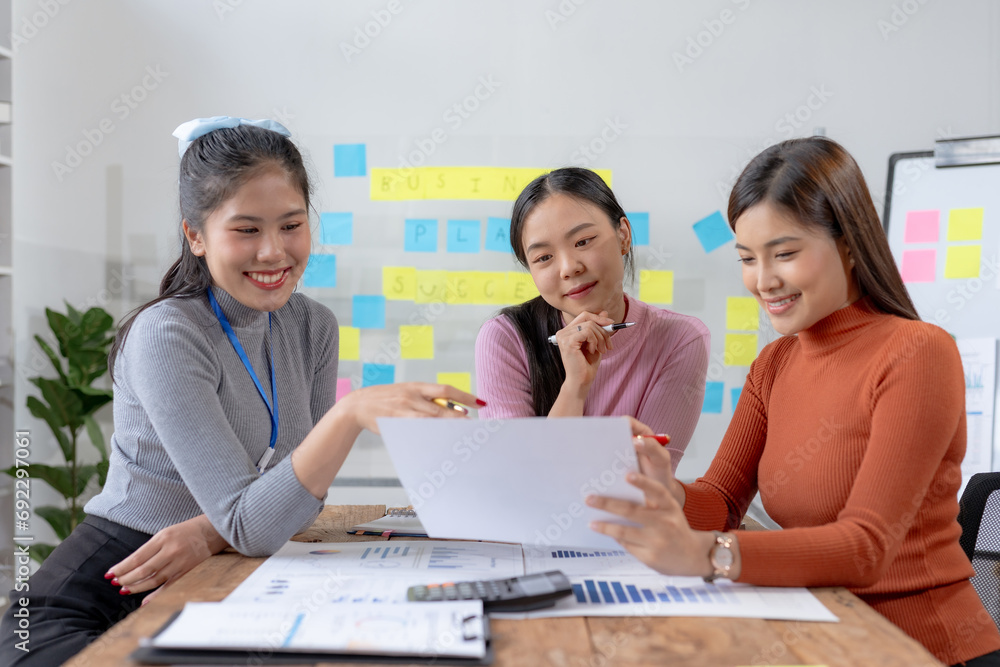Team of young Asian businesswomen plan and meeting together and present marketing ideas in the office. Team of young Asian businesswomen plan and meeting together and present marketing ideas in the office.