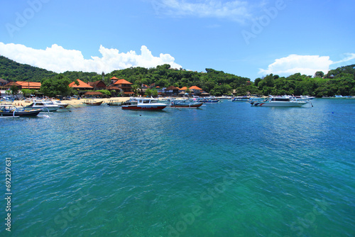 Padangbai in Bali, Indonesia with fishing boats in the sea photo