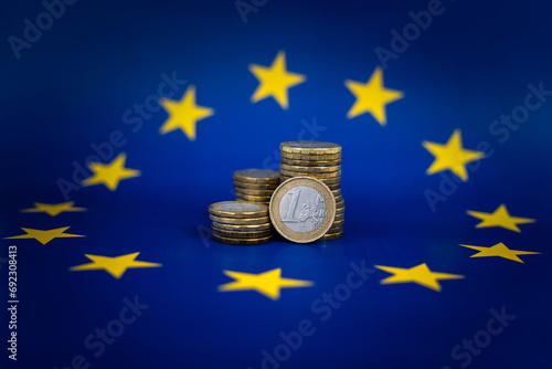 euro coins on background of the European flag. The concept of European financing. Business and work in Europe.