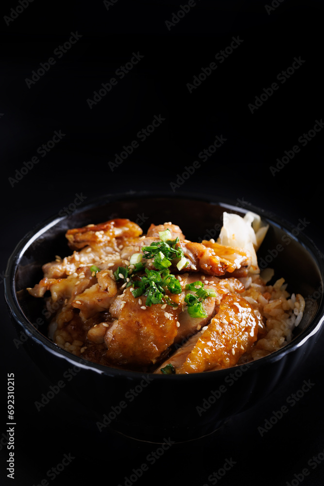 Grilled Chicken teriyaki rice Japanese food isolated in black background
