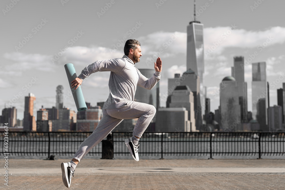 Man in sports suit training jogging. Running man in Manhattan. Morning sport workout jogger run in New York. Jogger run at sport training. Sportsman jogger running or jogging. Personal achievement Man in sports suit training jogging. Running man in Manhattan. Morning sport workout jogger run in New York. Jogger run at sport training. Sportsman jogger running or jogging. Personal achievement